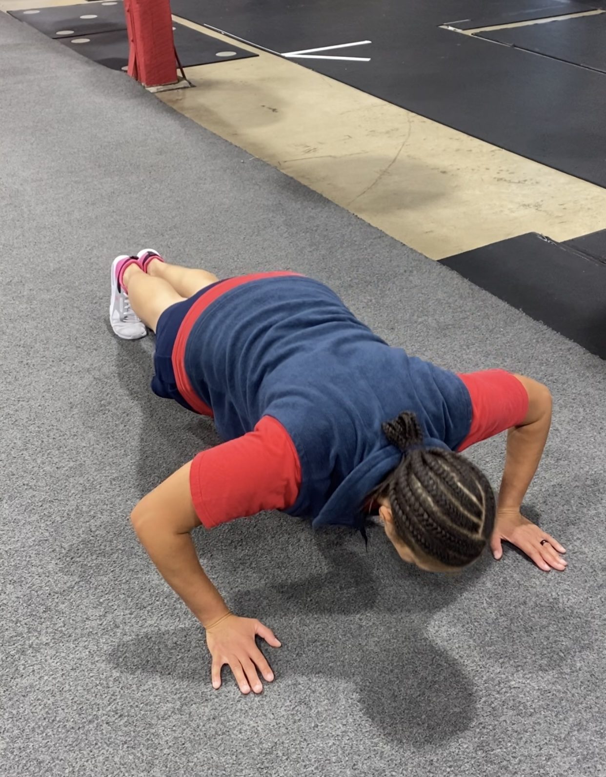 Client performing a push-up in the training facility